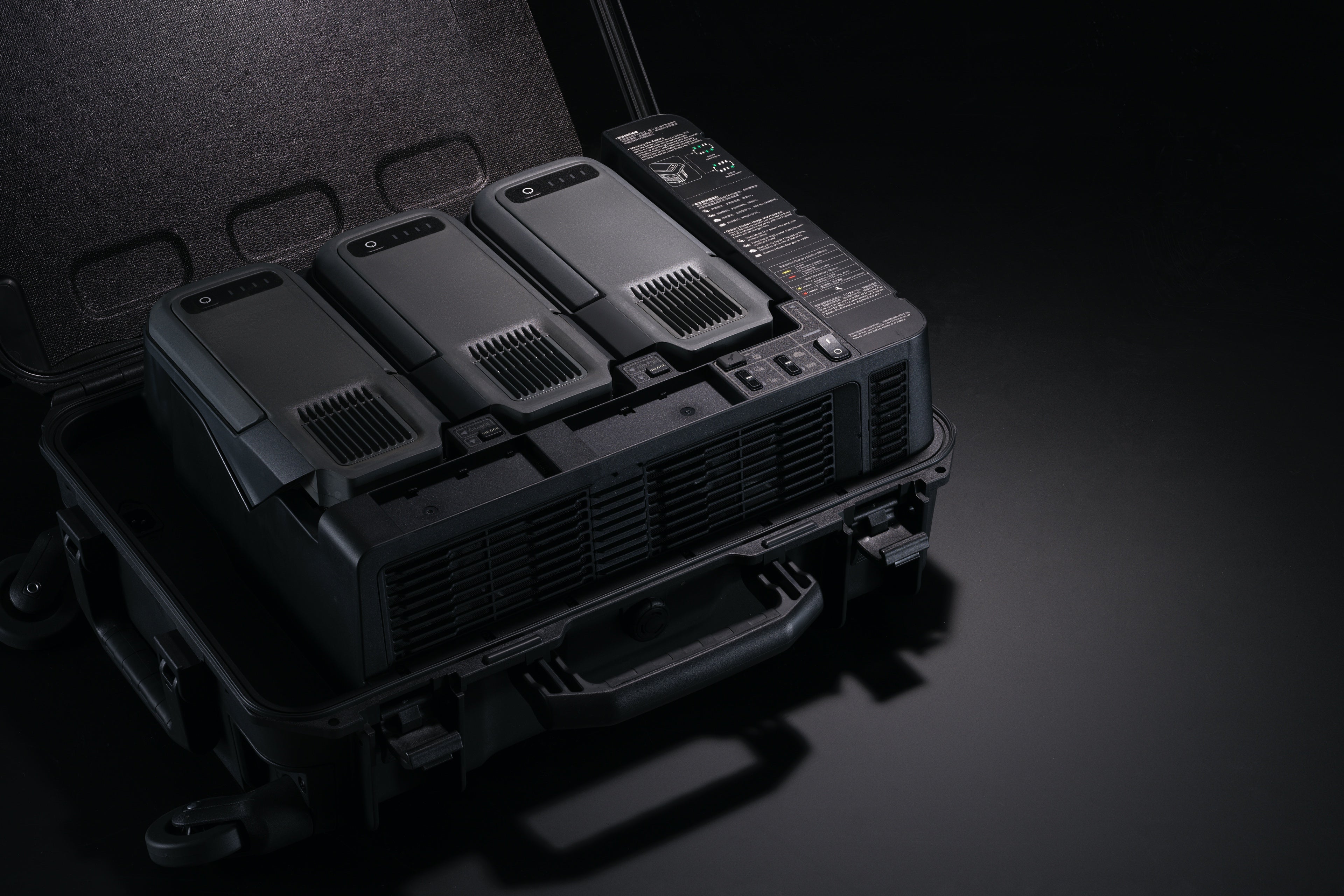 DJI BS100 Intelligent Battery Station for DJI Matrice 400 drone, shown with multiple battery slots and digital display.